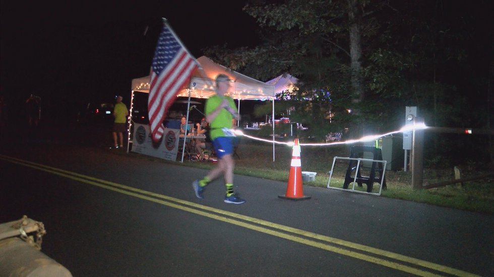 Will Turner crossing finish line of 45th Ironman race officially breaking world record.