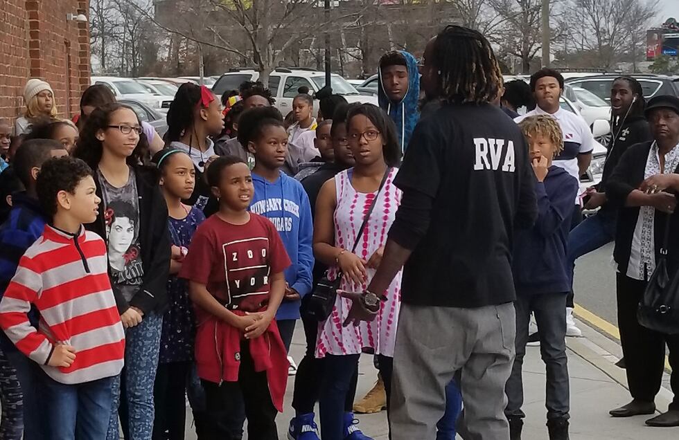 Campaign creator Lance Cooper stands with students outside of the movie theatre before seeing...