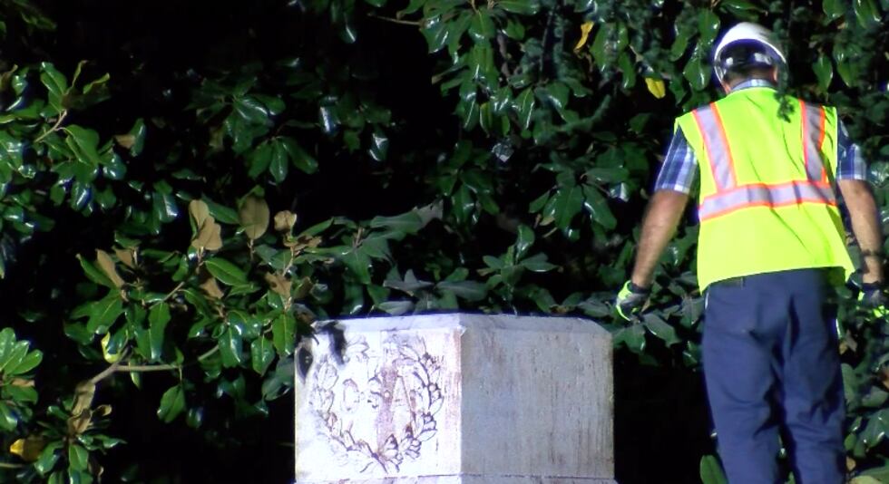 Workers remove the Confederate soldier statue from the Madison County Courthouse