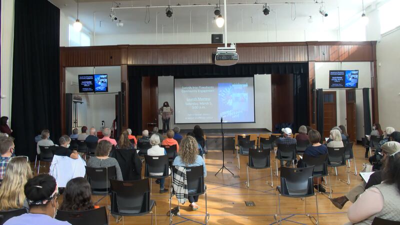 Jalene Schmidt in front of Swords of Plowshares presentation