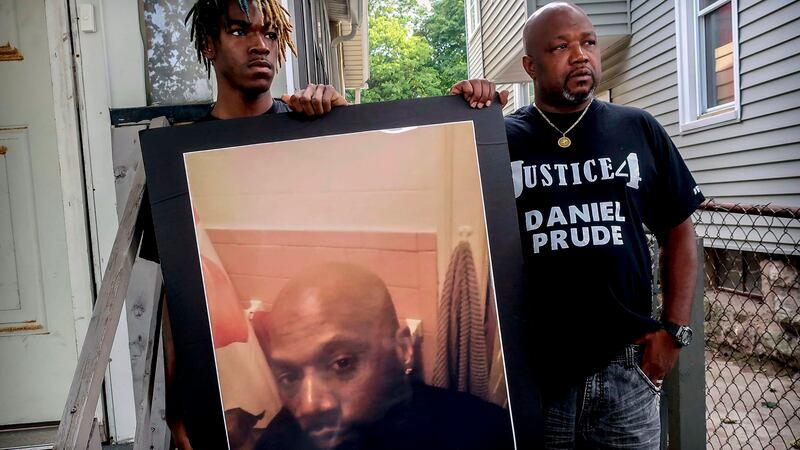 FILE - Armin Prude, left, and Joe Prude hold an enlarged photo of Daniel Prude, Sept. 3, 2020,...