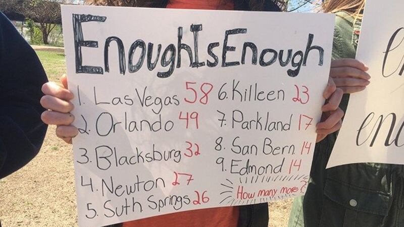 A student holds a sign at Brown's Island protesting gun violence. (Source: Kelly Avellino/NBC12)