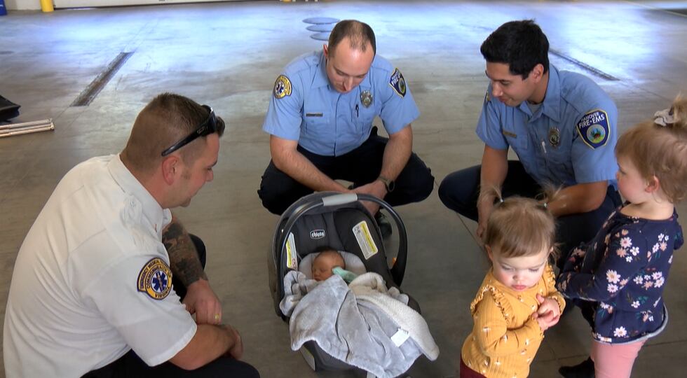 Firefighters reunited with the family they helped after the mother delivered her baby inside a...