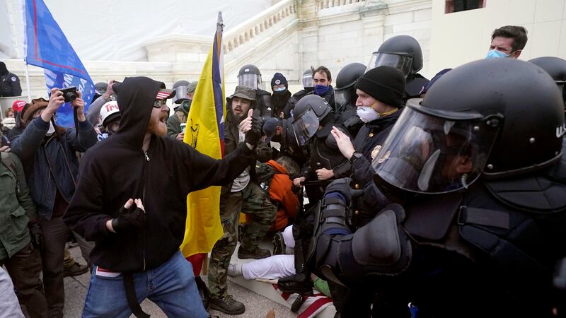 Trump supporters try to break through a police barrier, Wednesday, Jan. 6, 2021, at the...