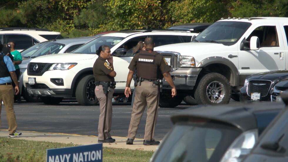 Law enforcement talks to parents waiting for kids after Dinwiddie High School students are...