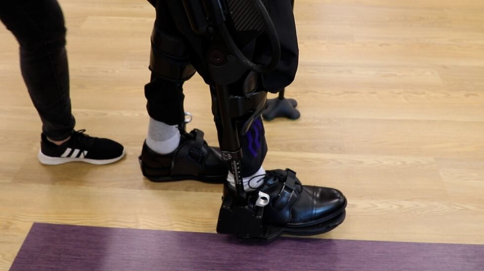Khalil Watson practices how to walk in his robotic exoskeleton.
