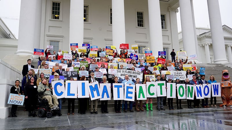 Clean energy supporters gather at the steps of the Virginia State Capitol to support...