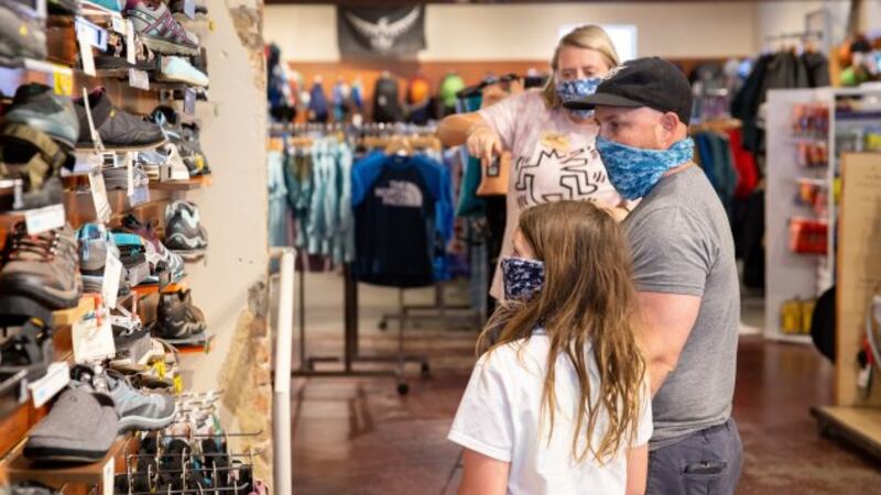 Jay Breneman and his daughter, Anna Grace, browse footwear at Walkabout Outfitter in Richmond,...