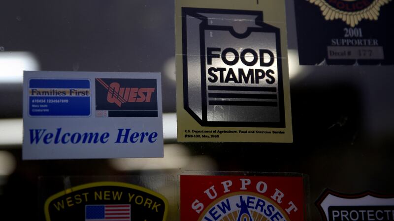 In this Jan. 12, 2015 file photo, a supermarket displays stickers indicating they accept food...