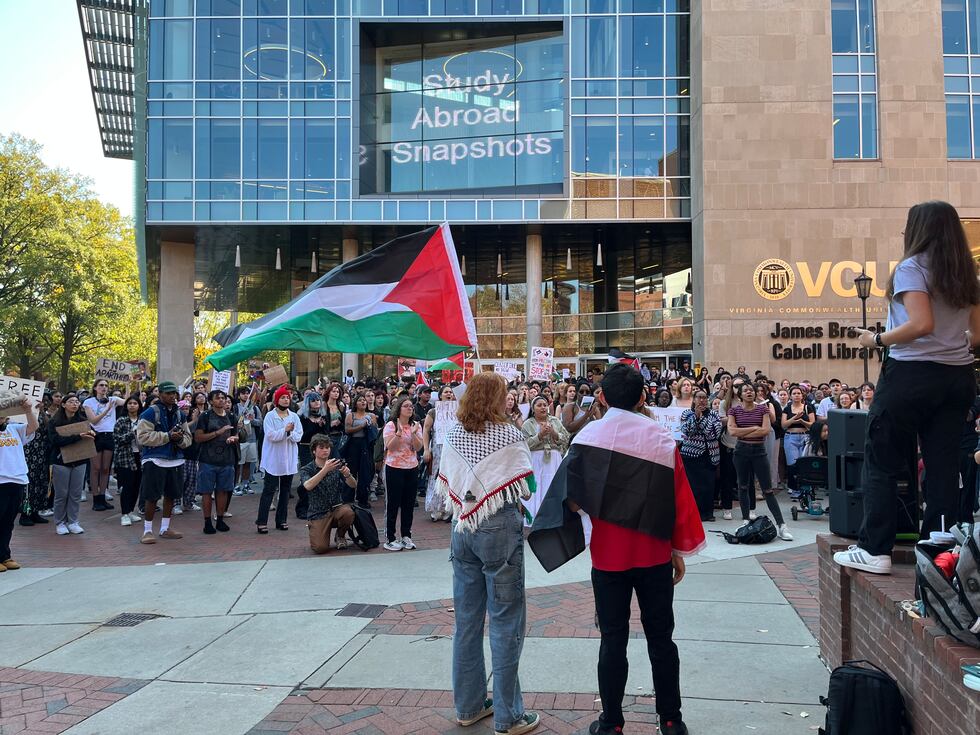 Many students held handmade posters and signs showing support for Palestine, some waved...