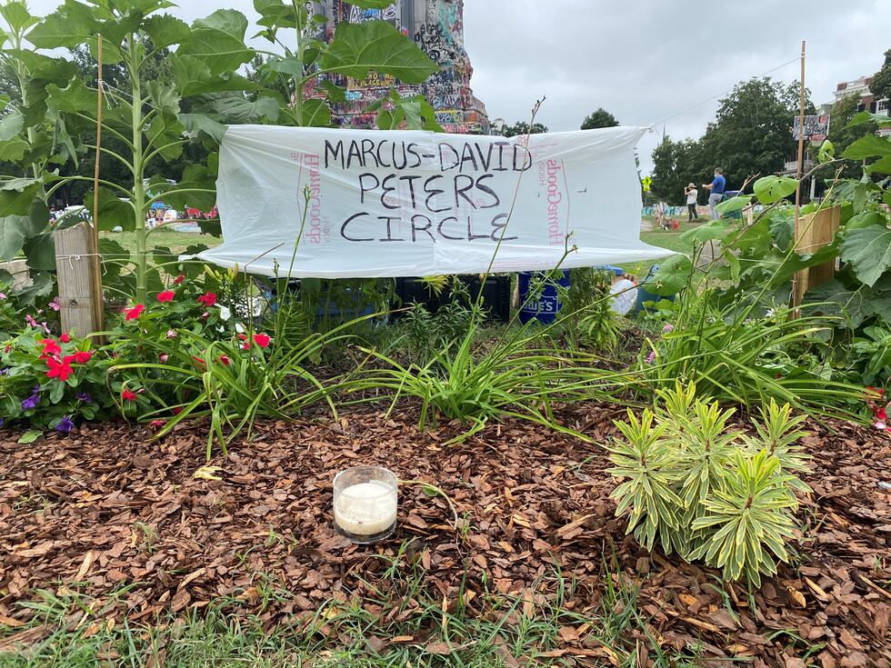 A plastic bag reading "Marcus-David Peters Circle" has been placed in the original sign's place.