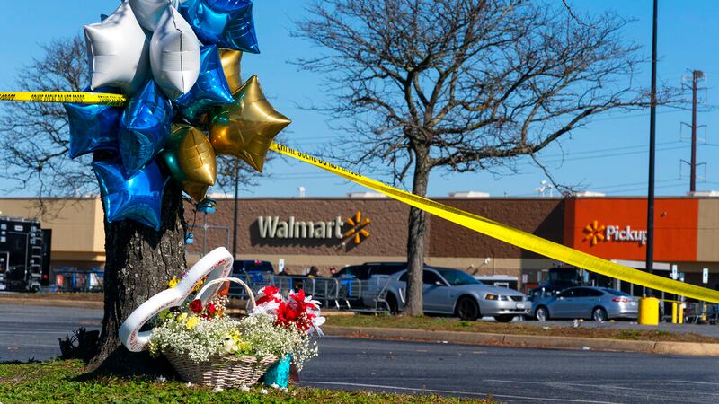 Flowers and balloons have been placed near the scene of a mass shooting at a Walmart,...
