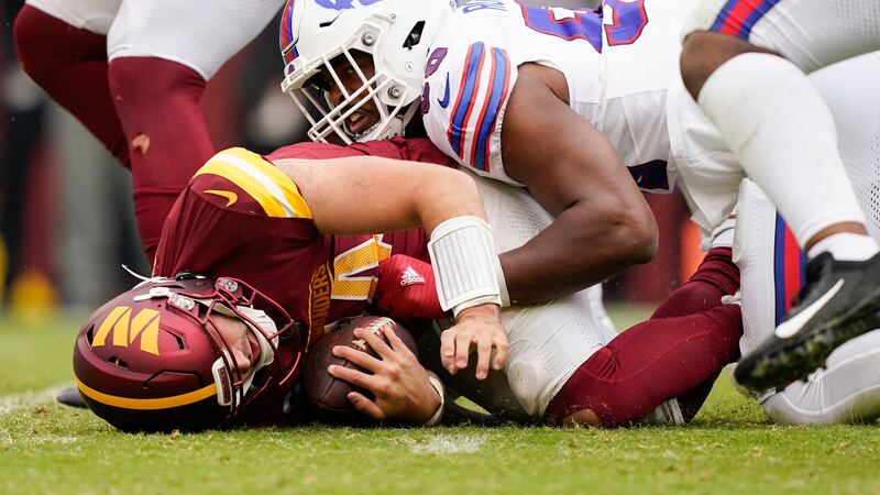 Washington Commanders quarterback Sam Howell (14) on the ground after being sacked by Buffalo...